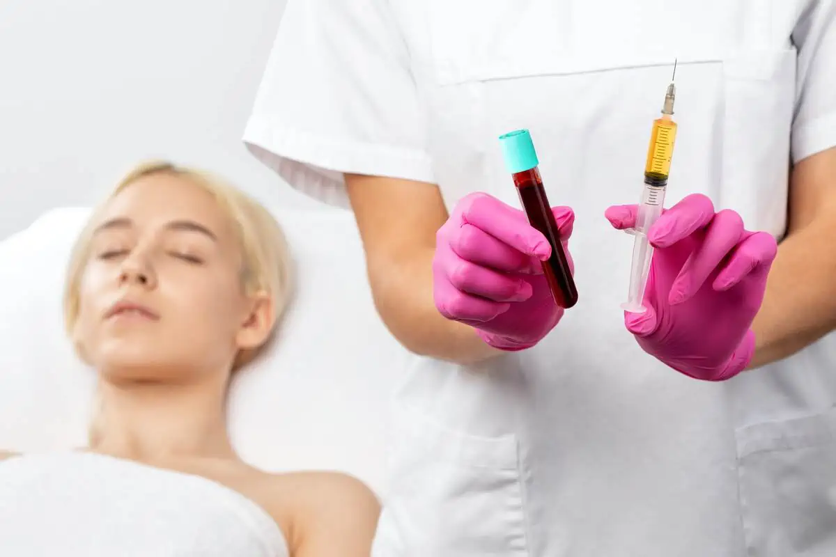 PRP (Platelet-Rich Plasma) treatment preparation with blood sample and syringe.