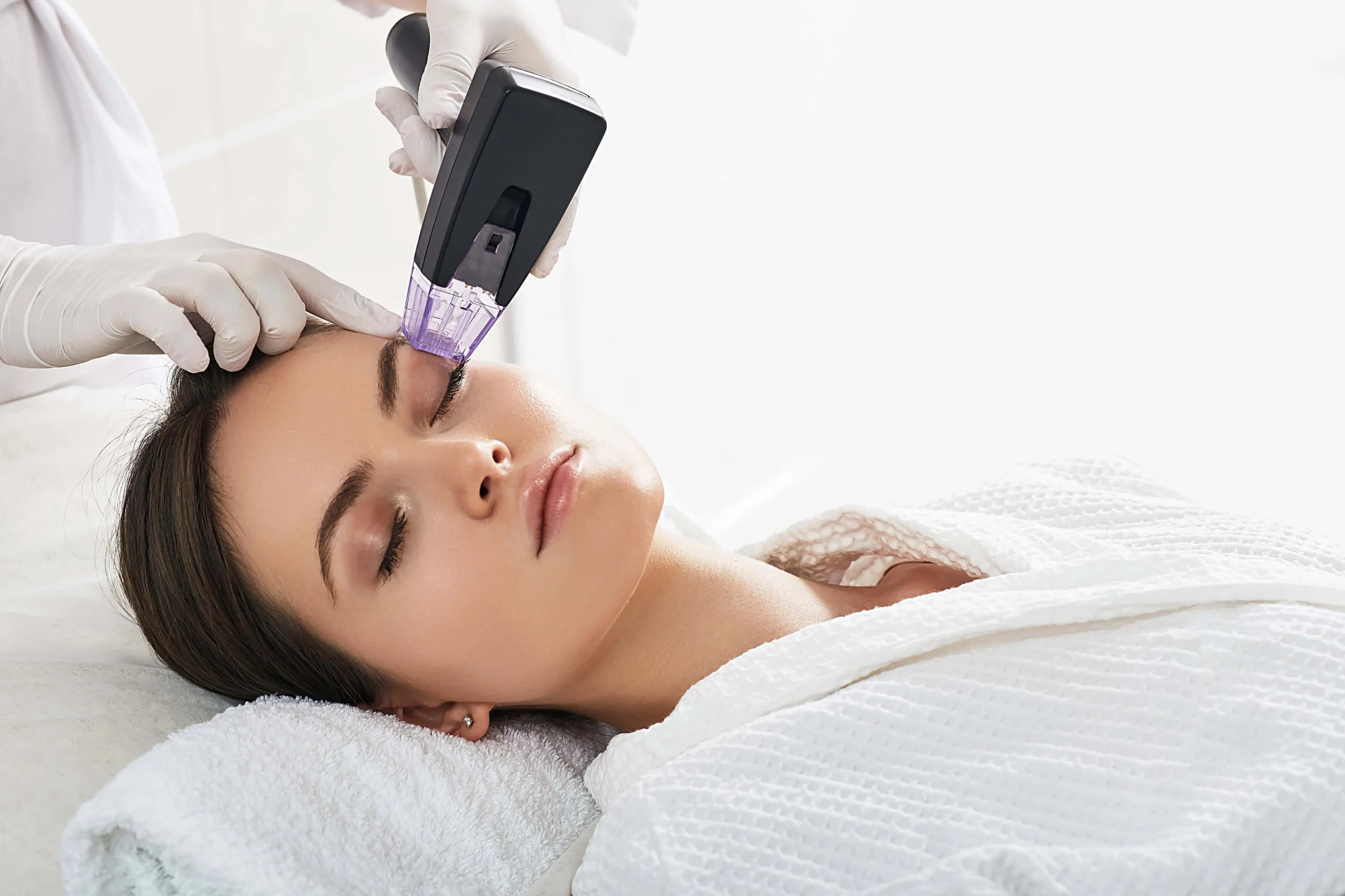 Technician performing Morpheus8 microneedling radiofrequency treatment on a woman's face at a medical spa in Old Bridge, NJ.